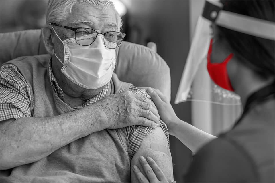 healthcare worker looking after elderly man