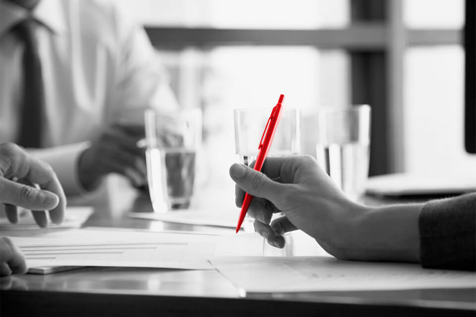 person taking notes during a meeting